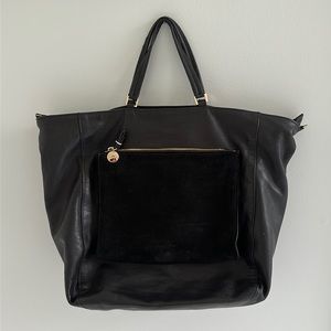 Clare V black leather tote with large suede outer pocket. Blue fabric lining.